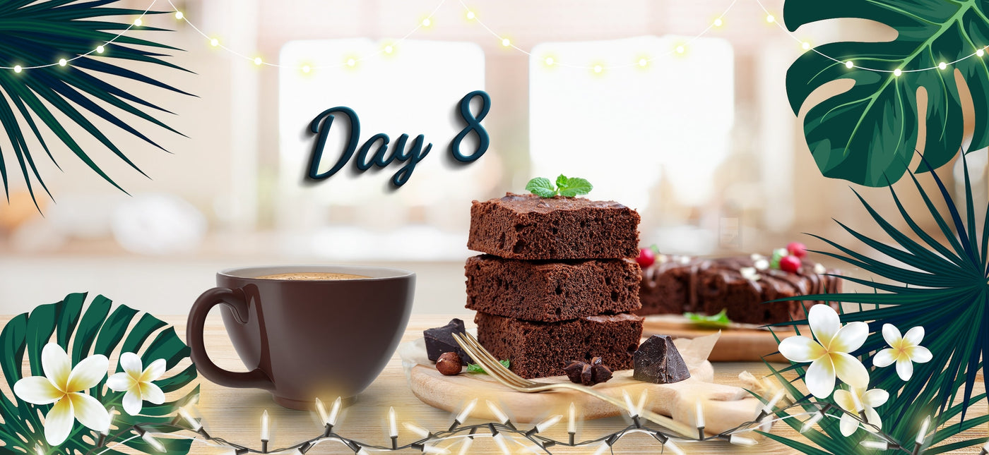 Coffee cup and brownies adorned with Christmas lights and plumeria flower. Text: 'Day 8'.